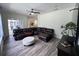 Comfortable living room with a leather sectional sofa and backyard access at 14936 Masthead Landing Cir, Winter Garden, FL 34787