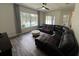 Inviting living room with a leather sectional sofa and pool views at 14936 Masthead Landing Cir, Winter Garden, FL 34787