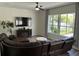 Comfortable living room featuring a large leather sectional, TV, and view of the backyard at 14936 Masthead Landing Cir, Winter Garden, FL 34787