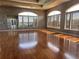 The meeting room is a flexible space with hardwood floors, bright windows, and calming gray walls at 14936 Masthead Landing Cir, Winter Garden, FL 34787