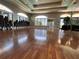 A spacious meeting room with hardwood floors and lots of natural light from large windows at 14936 Masthead Landing Cir, Winter Garden, FL 34787