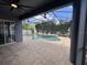 Inviting screened-in pool area with a central fountain and brick paver decking at 14936 Masthead Landing Cir, Winter Garden, FL 34787