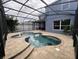 Inviting screened-in pool area with a central fountain and brick paver decking at 14936 Masthead Landing Cir, Winter Garden, FL 34787