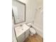 Updated bathroom with framed mirror, vanity, bathtub and earth-toned tile flooring at 1523 S Mellonville Ave, Sanford, FL 32771