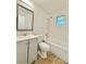 The renovated bathroom has a tub-shower, toilet, and a modern gray vanity at 1523 S Mellonville Ave, Sanford, FL 32771