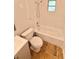 Bright bathroom features a shower-tub combo and tiled floor at 1523 S Mellonville Ave, Sanford, FL 32771