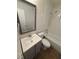 Updated bathroom with framed mirror, vanity, bathtub and earth-toned tile flooring at 1523 S Mellonville Ave, Sanford, FL 32771