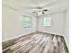 Spacious bedroom featuring laminate flooring and dual windows at 1523 S Mellonville Ave, Sanford, FL 32771