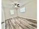 This bedroom has laminate floors, neutral paint, and lots of natural light at 1523 S Mellonville Ave, Sanford, FL 32771