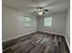 Spacious bedroom featuring laminate flooring and dual windows at 1523 S Mellonville Ave, Sanford, FL 32771