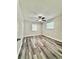 This bedroom offers laminate floors, neutral paint, and a ceiling fan at 1523 S Mellonville Ave, Sanford, FL 32771