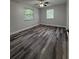Bedroom featuring laminate flooring, a ceiling fan, and dual windows at 1523 S Mellonville Ave, Sanford, FL 32771