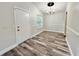 A dining area has laminate floors, a chandelier, and neutral wall color at 1523 S Mellonville Ave, Sanford, FL 32771
