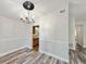 Dining room showcasing updated flooring and chandelier, open to other rooms at 1523 S Mellonville Ave, Sanford, FL 32771