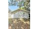 Side exterior view of the home, displaying the siding and window placement at 1523 S Mellonville Ave, Sanford, FL 32771