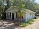 Charming home exterior featuring light-blue siding, black shutters, and a well-maintained yard with a small palm tree at 1523 S Mellonville Ave, Sanford, FL 32771