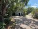 Charming home featuring a paved driveway and a cozy, inviting entrance surrounded by mature trees at 1523 S Mellonville Ave, Sanford, FL 32771