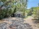 Charming home exterior with mature trees, neutral paint, and brick driveway at 1523 S Mellonville Ave, Sanford, FL 32771