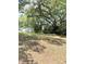 Well-maintained front yard with lush trees, framing the home's exterior at 1523 S Mellonville Ave, Sanford, FL 32771