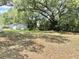 Landscaped front yard with trees and a charming exterior view of the home at 1523 S Mellonville Ave, Sanford, FL 32771