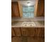 Kitchen features a double sink, granite countertops, and wood cabinetry at 1523 S Mellonville Ave, Sanford, FL 32771