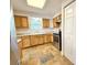 Updated kitchen featuring wood cabinets, stone countertops, stainless steel oven and stone flooring at 1523 S Mellonville Ave, Sanford, FL 32771