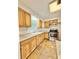 Kitchen featuring wood cabinets, granite countertops, and stainless steel appliances at 1523 S Mellonville Ave, Sanford, FL 32771