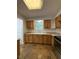 Well-lit kitchen featuring wooden cabinets, stone countertops, and modern appliances at 1523 S Mellonville Ave, Sanford, FL 32771