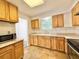 Kitchen featuring wooden cabinets, stone countertops, stainless steel oven, and window at 1523 S Mellonville Ave, Sanford, FL 32771