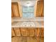 Kitchen sink with granite countertops and wooden cabinets at 1523 S Mellonville Ave, Sanford, FL 32771