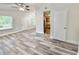 Open floor plan living room with laminate flooring and neutral color scheme at 1523 S Mellonville Ave, Sanford, FL 32771
