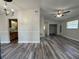 The open-concept living room features new flooring and neutral paint, creating a welcoming atmosphere at 1523 S Mellonville Ave, Sanford, FL 32771