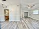 Open floor plan integrates the kitchen, dining, and living areas with new flooring at 1523 S Mellonville Ave, Sanford, FL 32771