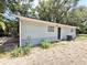 Side exterior featuring brick paving, door, and A/C unit at 1523 S Mellonville Ave, Sanford, FL 32771