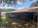 Backyard view featuring the screened-in porch and the home's exterior at 1606 Red Clover Ct, Orlando, FL 32825