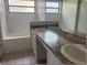 Bright bathroom with double sinks, tub, and tile flooring at 1606 Red Clover Ct, Orlando, FL 32825