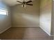Neutral bedroom featuring new carpet, fan/light fixture, and bright natural light at 1606 Red Clover Ct, Orlando, FL 32825