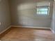 Cozy bedroom featuring laminate flooring, natural light, and neutral paint at 1606 Red Clover Ct, Orlando, FL 32825