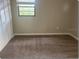 Cozy bedroom with carpeting, closet, and a bright window at 1606 Red Clover Ct, Orlando, FL 32825