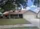 Charming single-story home with a two-car garage and well-maintained front yard at 1606 Red Clover Ct, Orlando, FL 32825