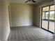 Bright sunroom with tile flooring, ceiling fan, and sliding glass doors to the backyard at 1606 Red Clover Ct, Orlando, FL 32825