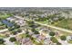 Lush aerial view of a neighborhood featuring ponds and nearby commercial establishments creating a blend of convenience and nature at 1614 Christa Ct, St Cloud, FL 34772
