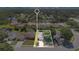 Highlighted aerial shot of property close to community, showcasing its location amidst lush trees and a well-maintained neighborhood at 1614 Christa Ct, St Cloud, FL 34772
