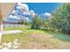 Spacious backyard featuring lawn, perimeter fence, and the home's rear exterior at 1614 Christa Ct, St Cloud, FL 34772