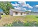 Spacious backyard featuring lawn, partial perimeter fence, and the home's rear exterior at 1614 Christa Ct, St Cloud, FL 34772