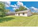 Spacious backyard featuring lawn, partial perimeter fence, and the home's rear exterior at 1614 Christa Ct, St Cloud, FL 34772