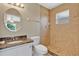 Updated bathroom with tiled walk-in shower, granite vanity, and decorative mirror at 1614 Christa Ct, St Cloud, FL 34772