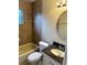 Hall bath with tiled tub, vanity, and neutral wall color at 1614 Christa Ct, St Cloud, FL 34772