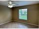 Neutral bedroom featuring tile floors and a window with outside view at 1614 Christa Ct, St Cloud, FL 34772