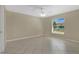 Inviting bedroom with a ceiling fan, tile flooring, and a large window for natural light at 1614 Christa Ct, St Cloud, FL 34772